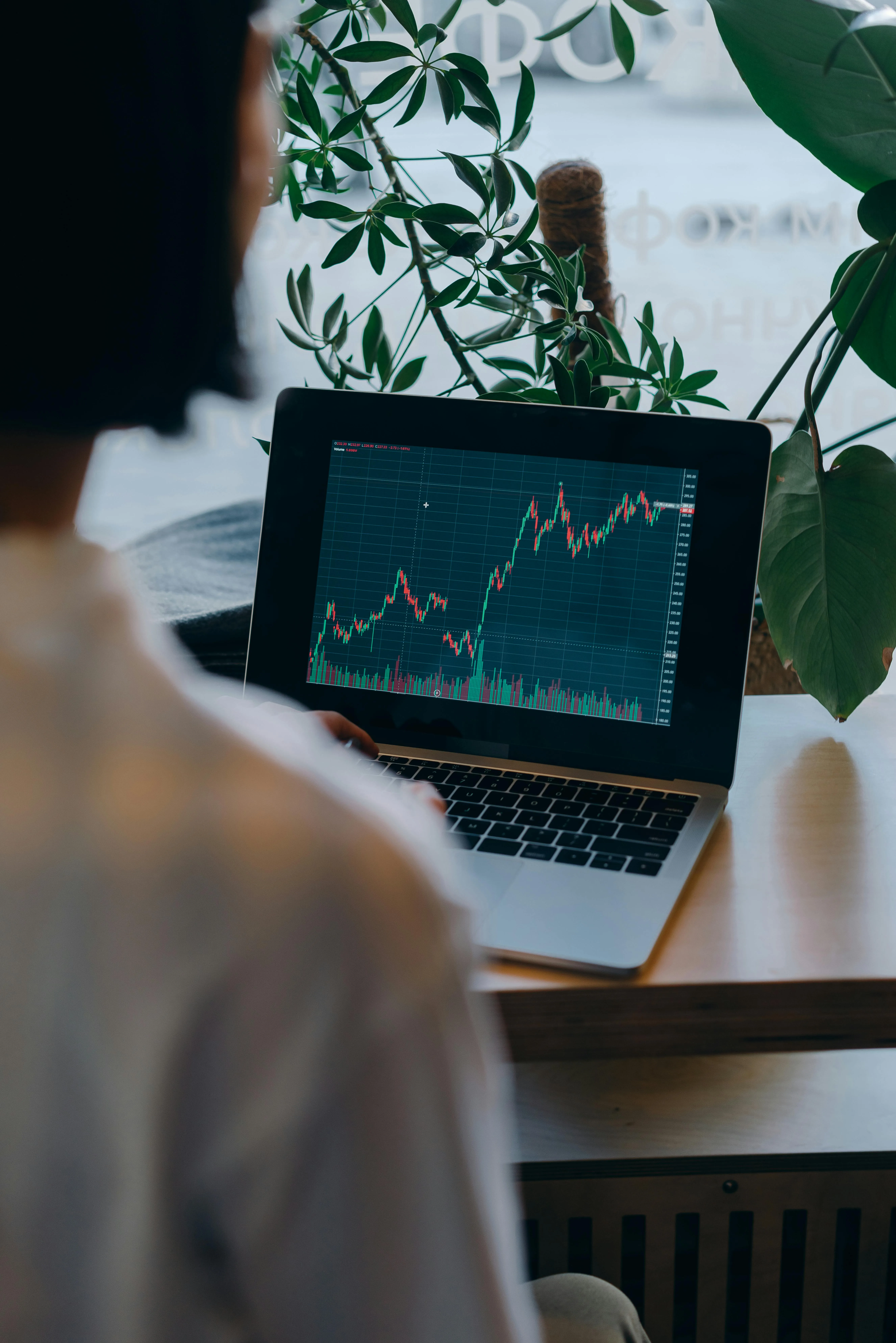 Professional accountant analyzing financial growth charts on a laptop at a modern office desk