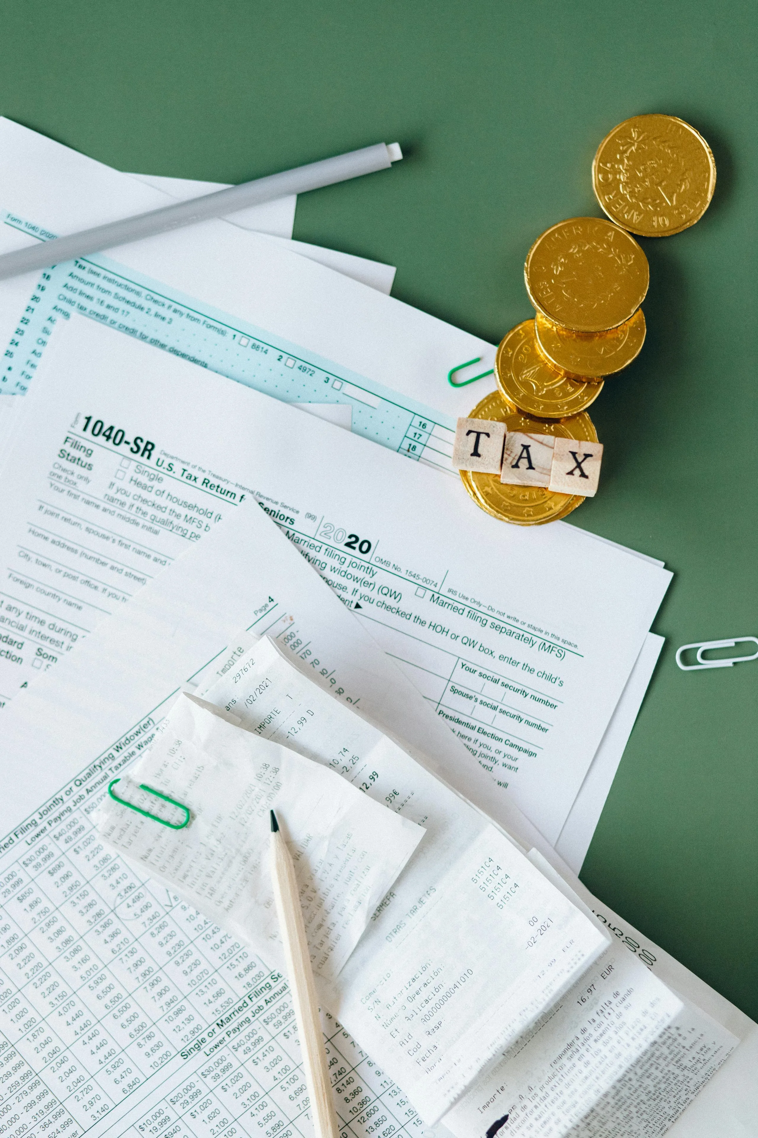 US 1040 tax forms with calculator and pen on desk representing sales tax nexus compliance for Shopify merchants