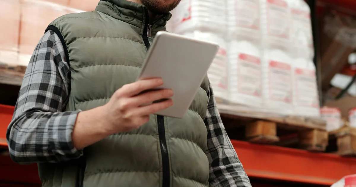 Warehouse employee managing product inventory with a tablet — Shopify item matching to QuickBooks Online with WeIntegrate